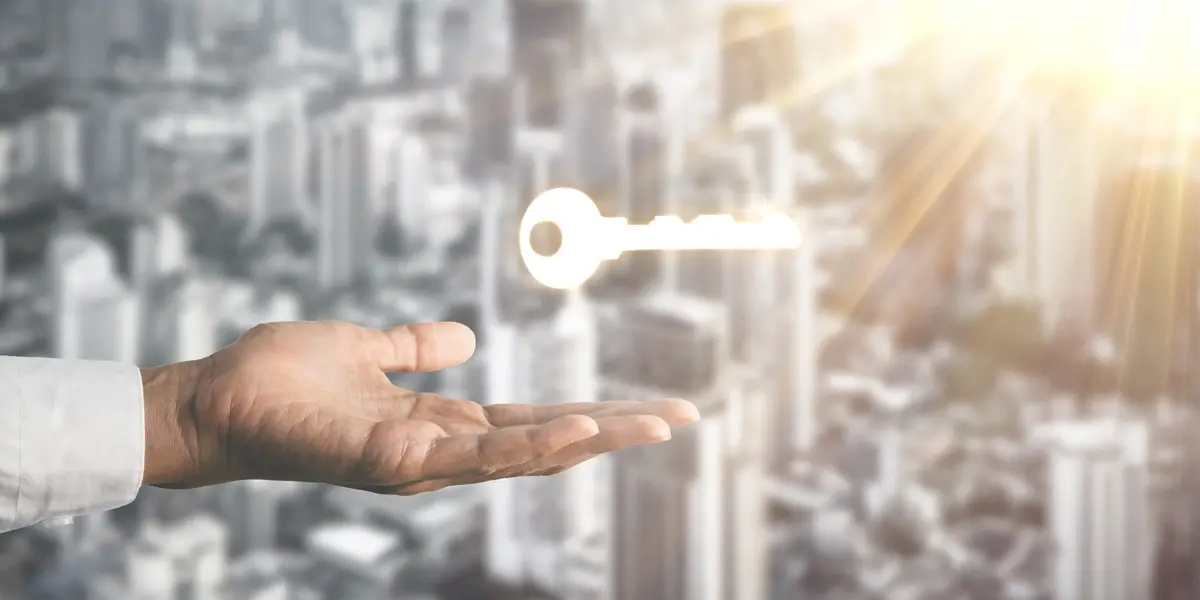 businessman-holding-key-with-blur-city-scape-background-sun-light-key-success-c